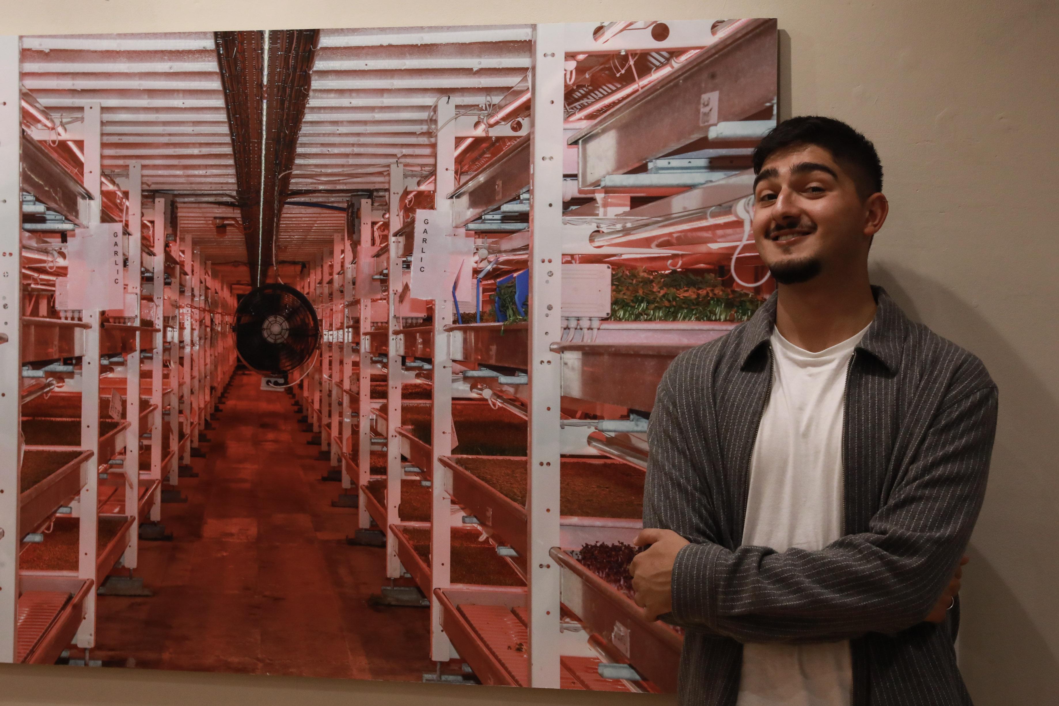Jai Toor pictured with his photographic work, "The Future of Farming".